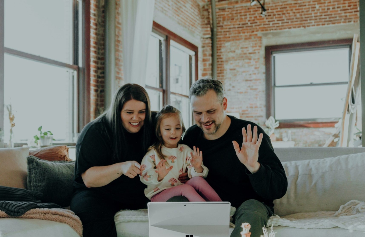 parents and child say hi on tablet