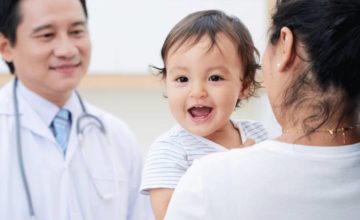 Smiling baby and mother at the pediatrician