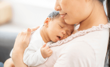 mom holds sleeping baby