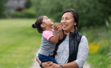 native american mother and daughter at park